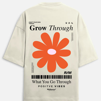 Beige t-shirt with orange flower graphic and motivational text on a white background
