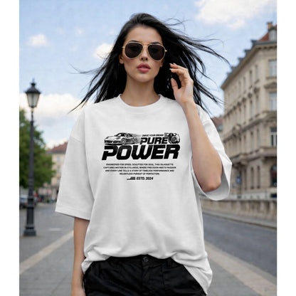 Woman wearing a white t-shirt with 'Pure Power' text on a city street.