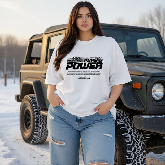 Woman wearing a white t-shirt with 'Pure Power' text in front of a Jeep in a snowy setting