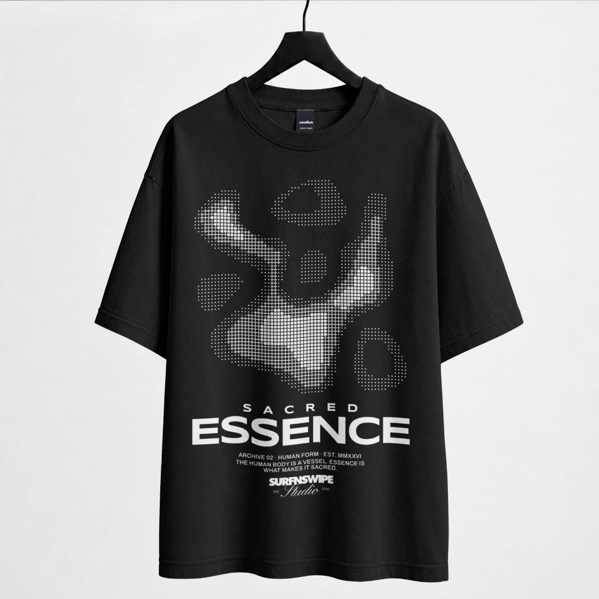 A black short-sleeve t-shirt hanging on a black hanger against a light gray background. The shirt features a large white and gray pixelated graphic of a figure on the chest, with the text 'SACRED ESSENCE' printed in white below it.