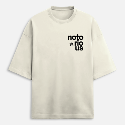 Beige t-shirt with 'notorious' text on a light gray background