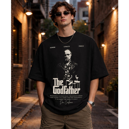Person wearing a black 'The Godfather' t-shirt in an urban alleyway.