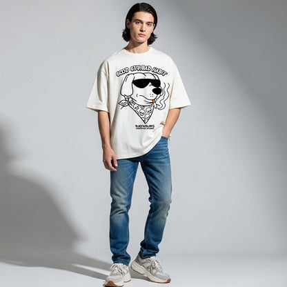 Person wearing a white t-shirt with a graphic design and blue jeans on a gray background