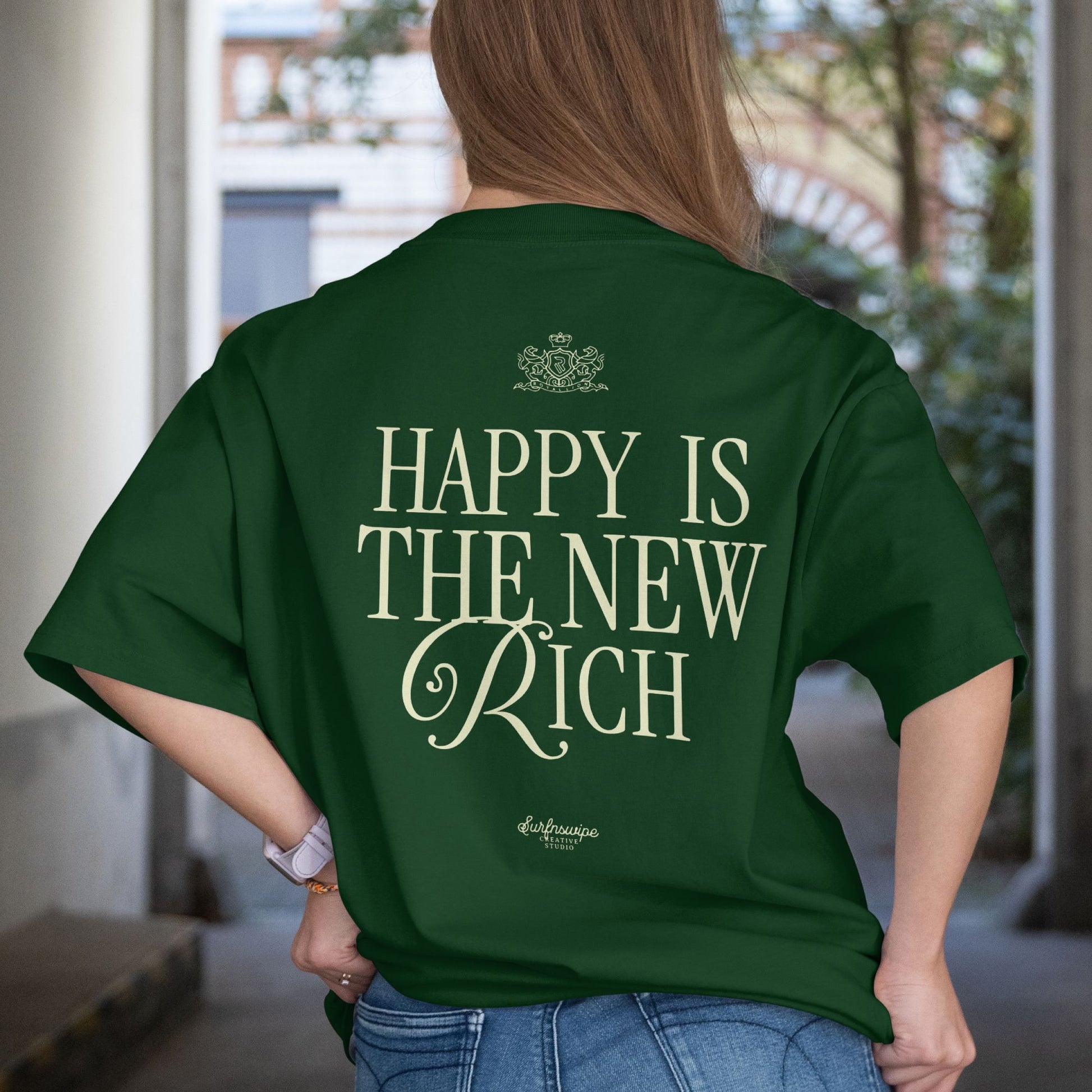 Person wearing a green t-shirt with 'Happy is the New Rich' text on the back.