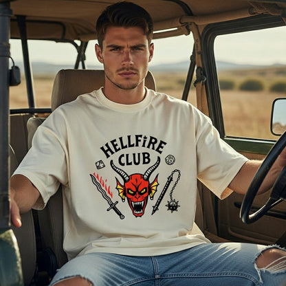 Man sitting in a vehicle wearing a 'Hellfire Club' t-shirt with a graphic design.