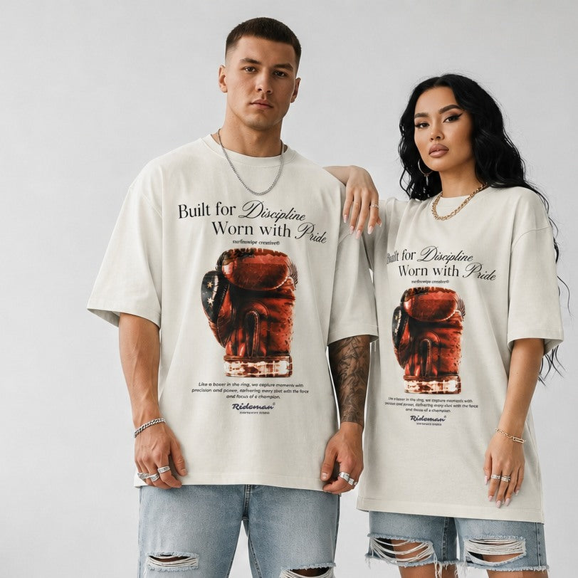 Man and woman both wearing cream Heritage Boxing Glove graphic tees