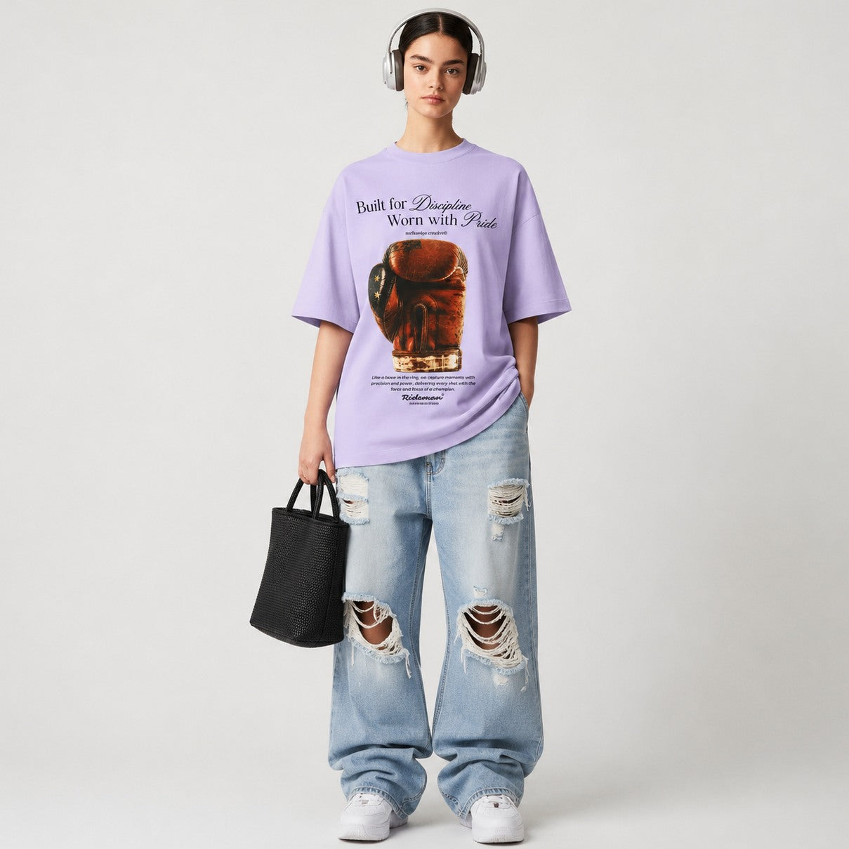 Woman wearing lavender Heritage Boxing Glove tee and baggy jean