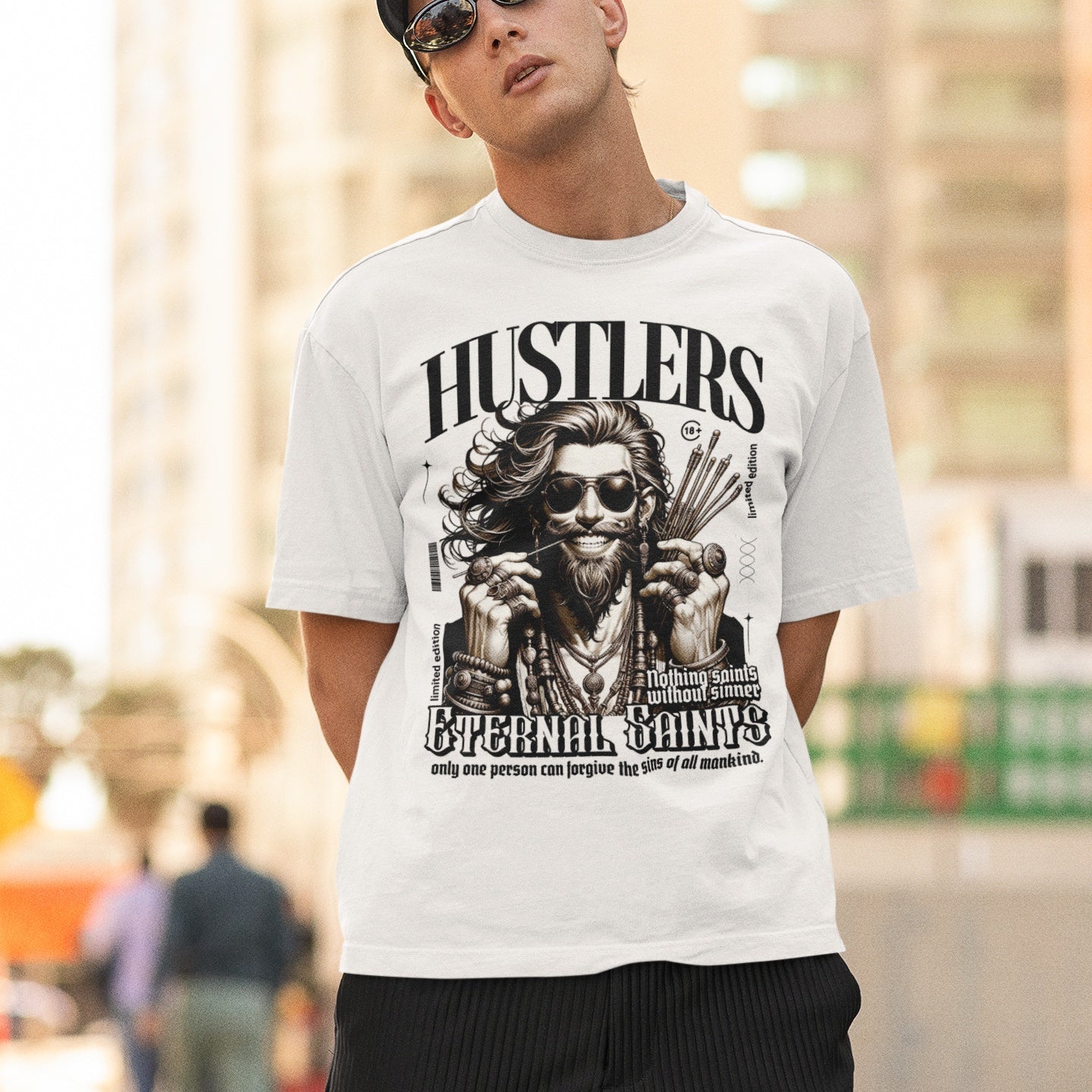 A person wearing a white oversized fit t-shirt with a graphic print in the center.