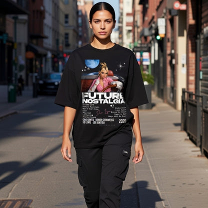 Person wearing a black t-shirt with graphic design and text on a city street.