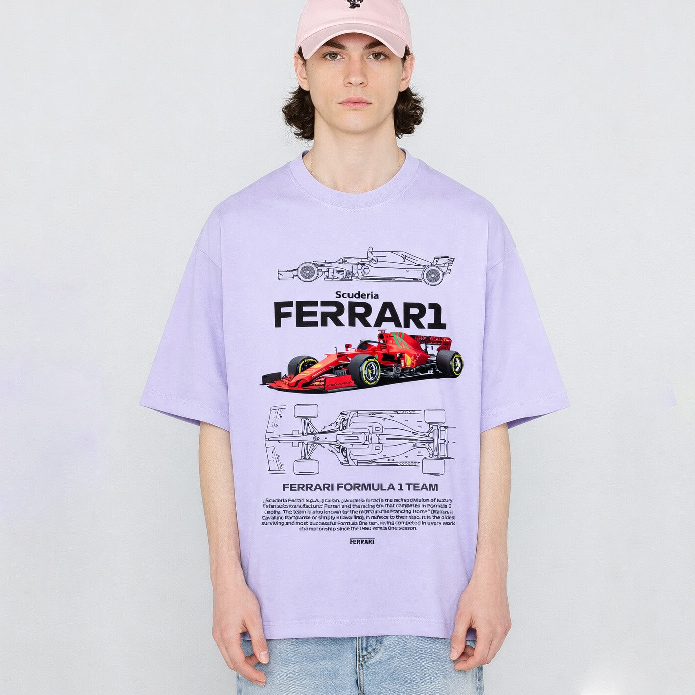 Person wearing a light purple t-shirt with Ferrari Formula 1 team graphics on a white background