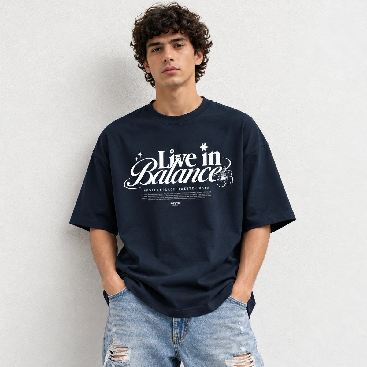 Man wearing Navy oversized boxy fit tee with Live in Balance graphic print
