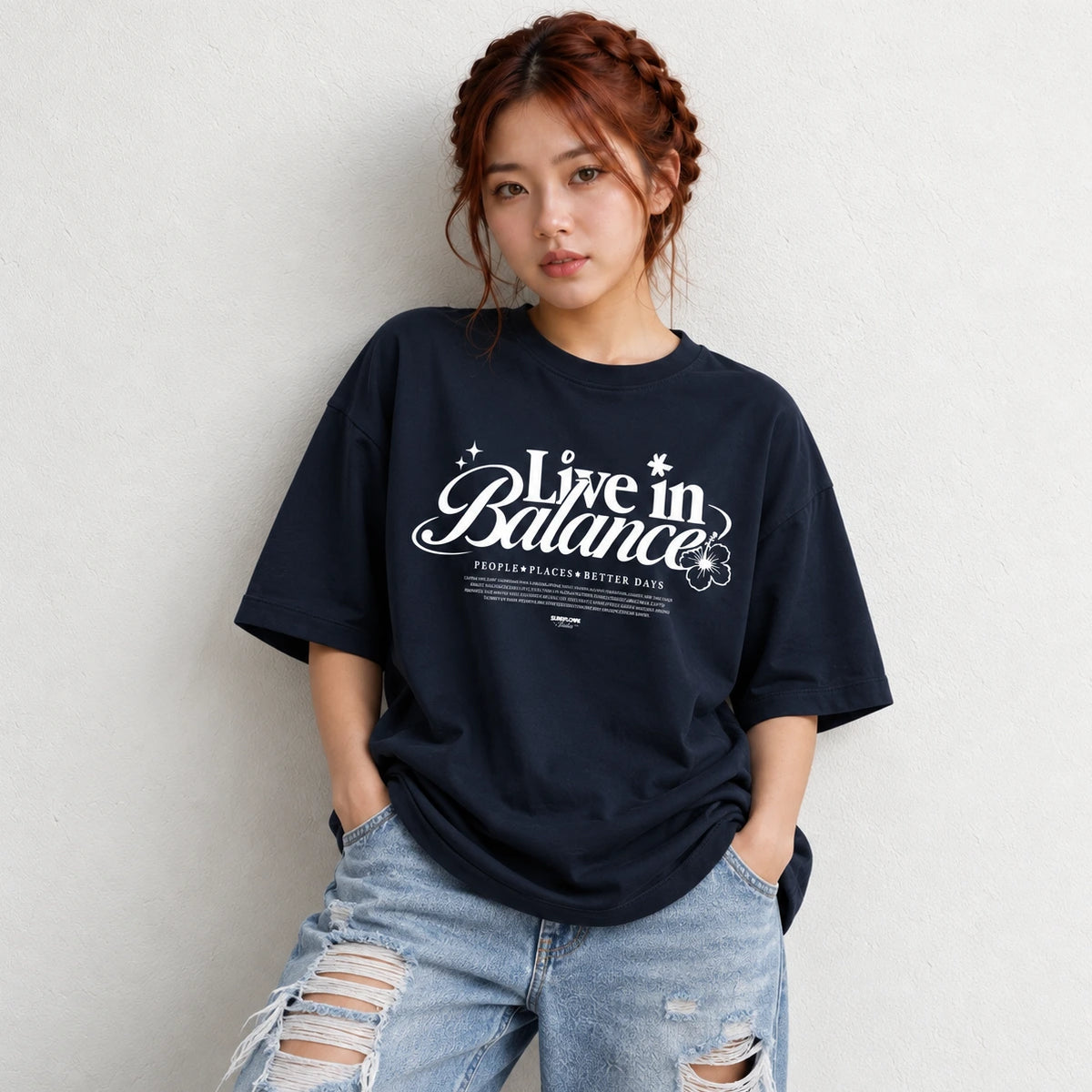 Woman wearing Navy oversized boxy fit tee with Live in Balance graphic print