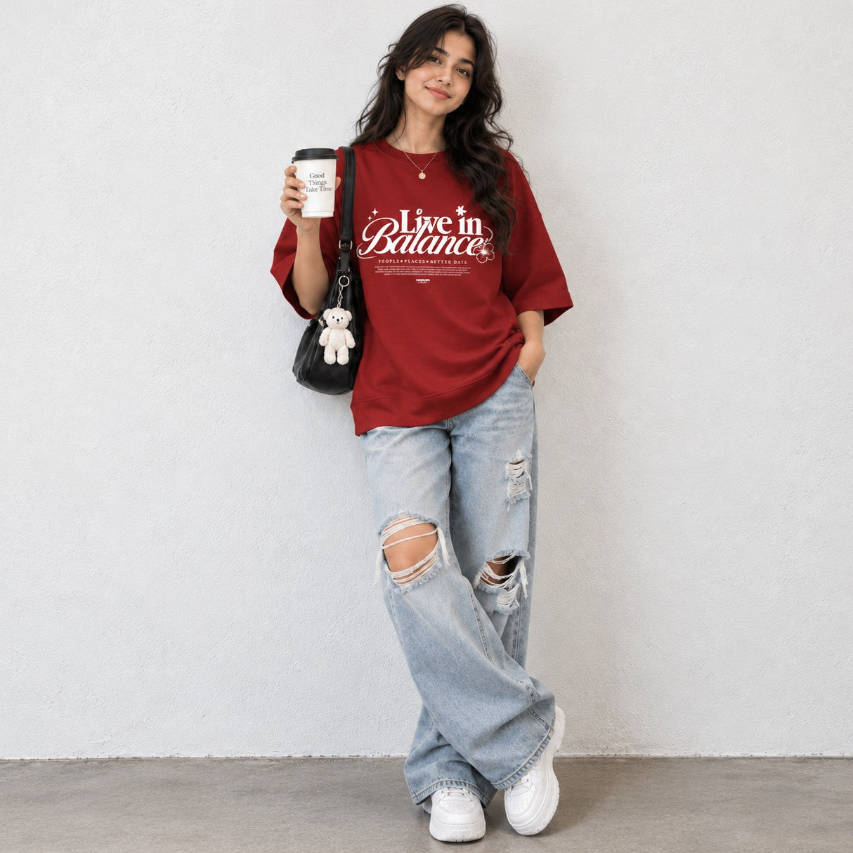 Woman wearing Red oversized boxy fit tee with Live in Balance graphic print
