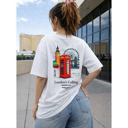 Person wearing a white t-shirt with London-themed graphics and text.