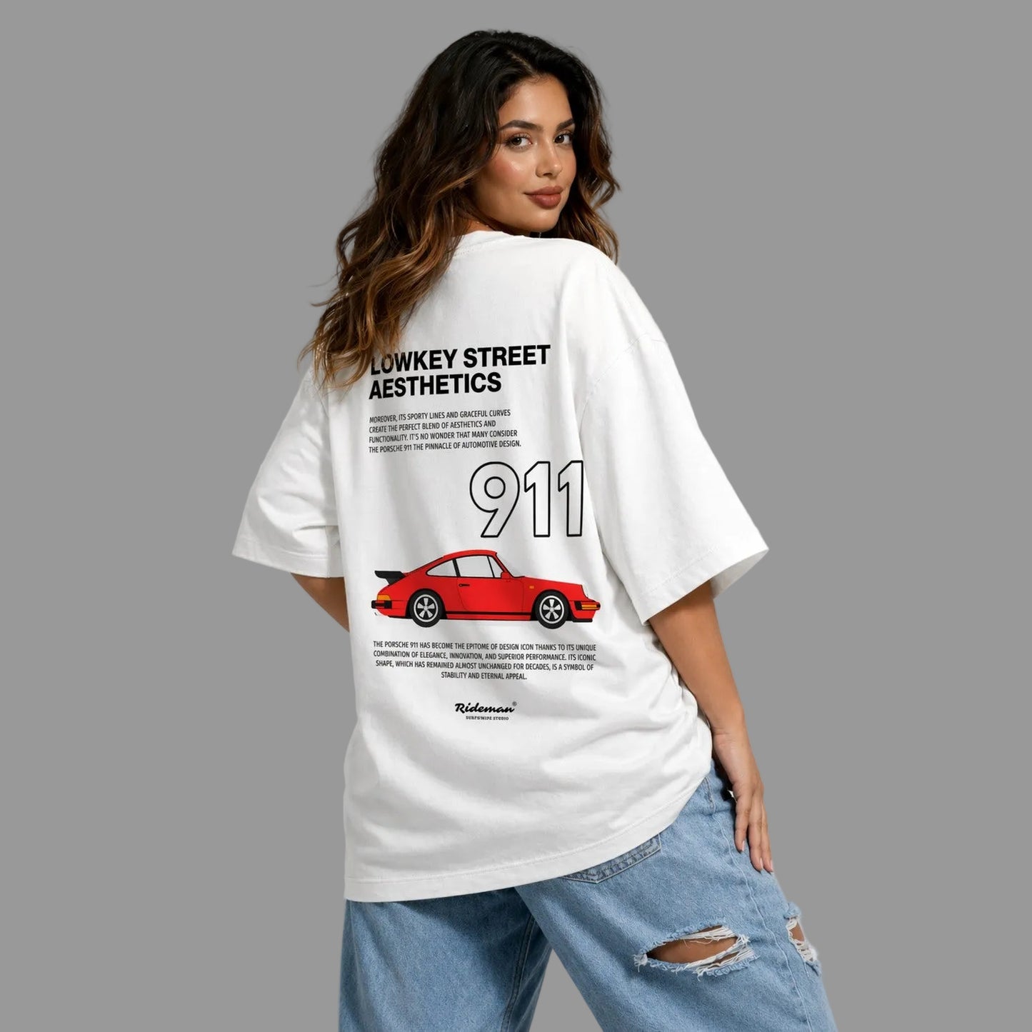 Woman wearing a white t-shirt with a graphic design and text, standing against a plain background