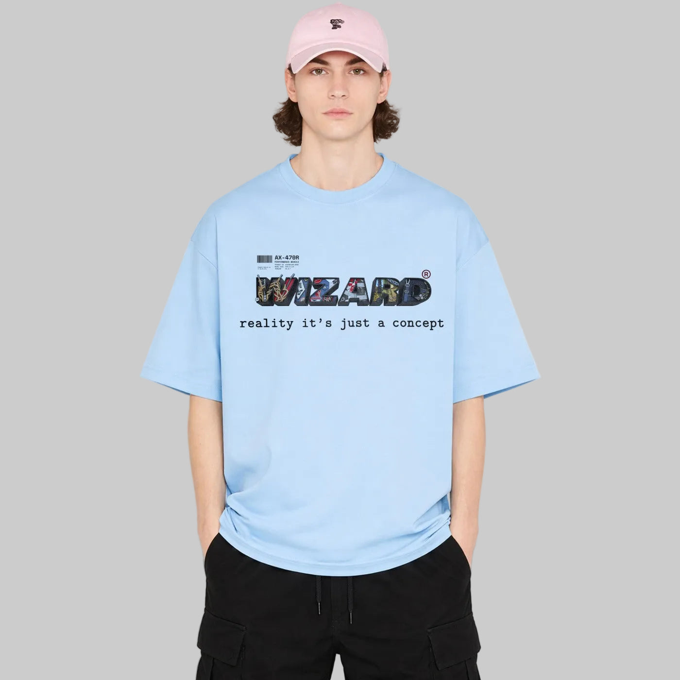 Person wearing a light blue t-shirt with text and a pink cap on a white background