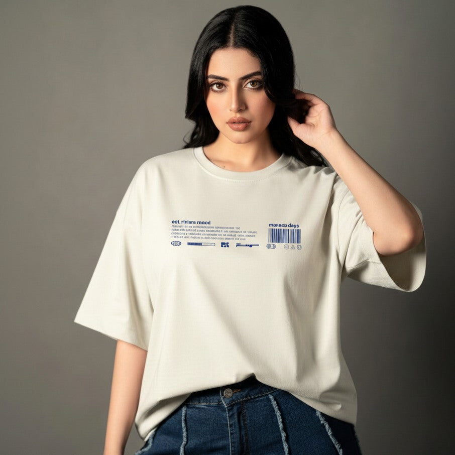 Woman wearing a light-colored t-shirt with text and graphics on a gray background