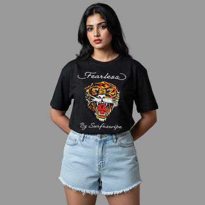 Woman wearing a black t-shirt with a tiger graphic and text, standing against a gray background