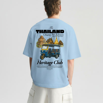 Light blue t-shirt with a graphic design on the back, featuring text and an illustration of a tuk-tuk and temples.