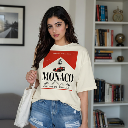 Woman wearing a 'Monaco' themed t-shirt in a room with books and decor.