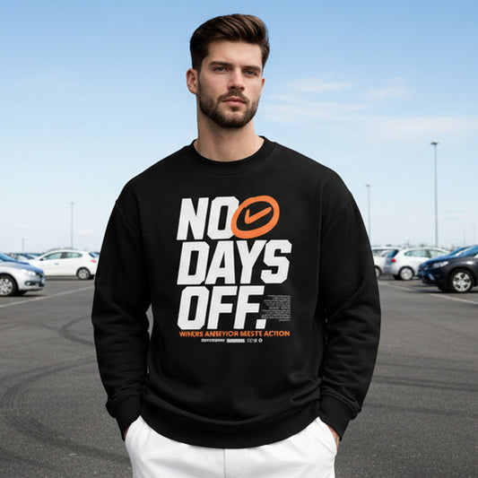 Man wearing a black sweatshirt with 'NO DAYS OFF' text in an urban setting