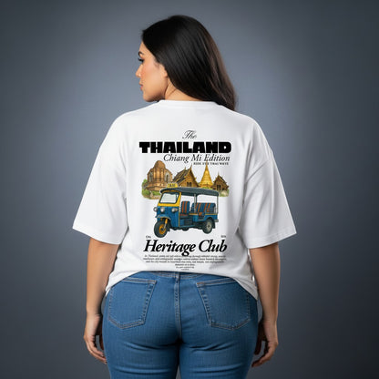 Person wearing a white t-shirt with 'The Thailand Heritage Club' design on the back.