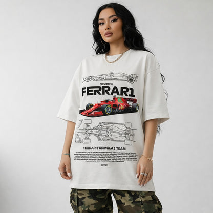 Person wearing a white Ferrari t-shirt with car graphics on a plain background