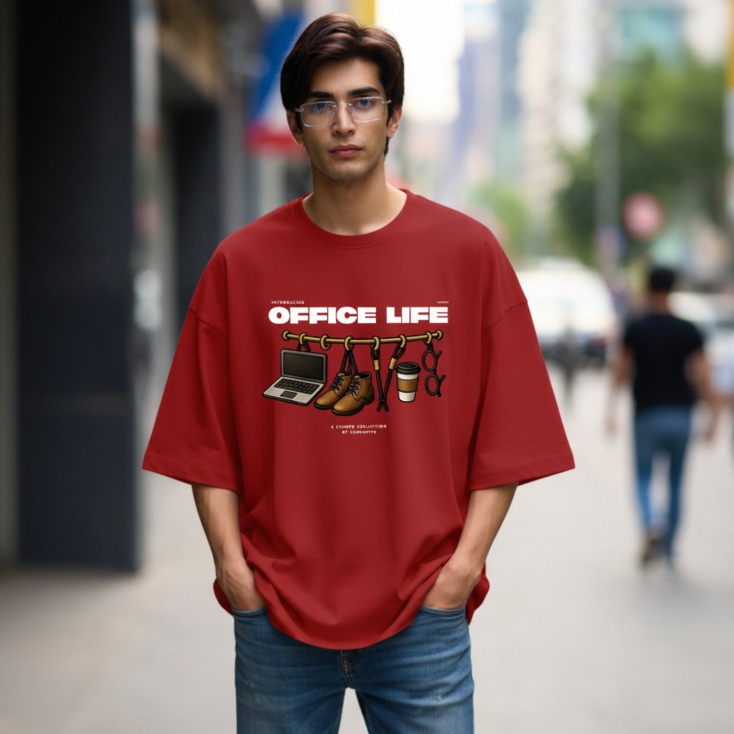Person wearing a red 'Office Life' t-shirt with graphic design on a city street.
