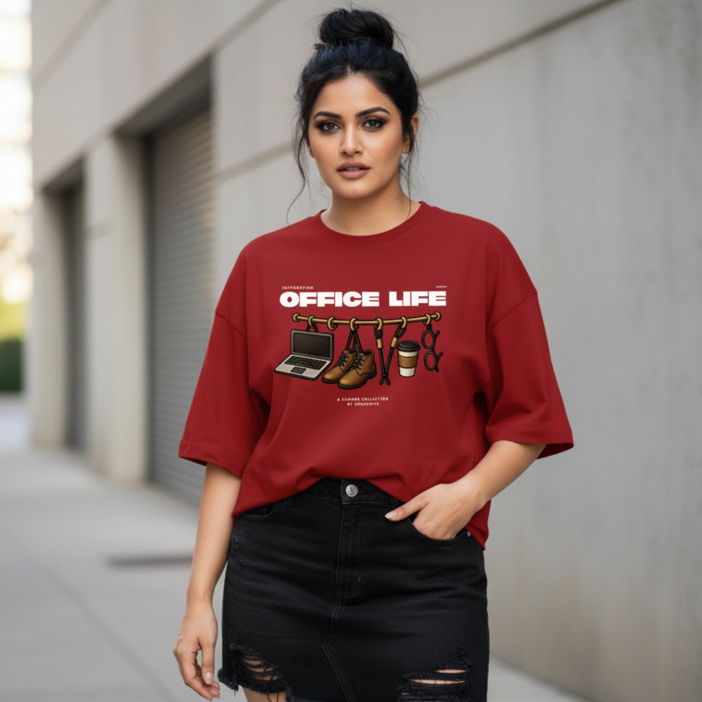 Woman wearing a red 'Office Life' t-shirt with graphic design outdoors.