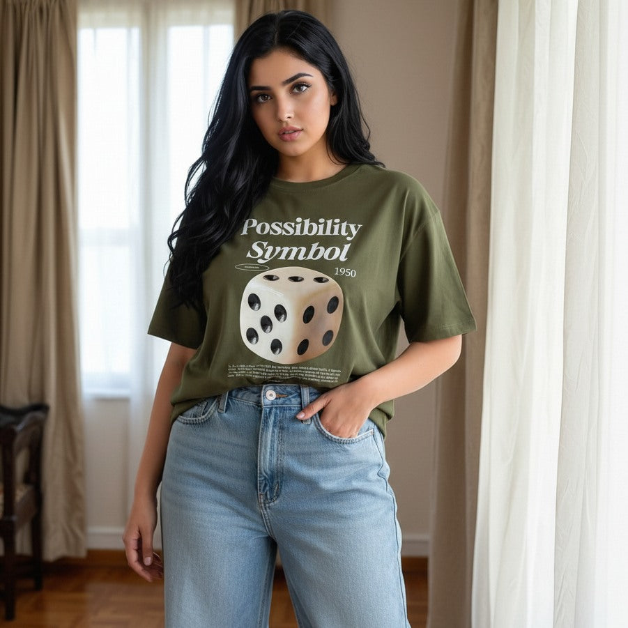 Woman wearing a green t-shirt with a graphic design and text, standing indoors.