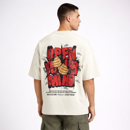 Man wearing a white t-shirt with graphic design on the back, standing against a white background