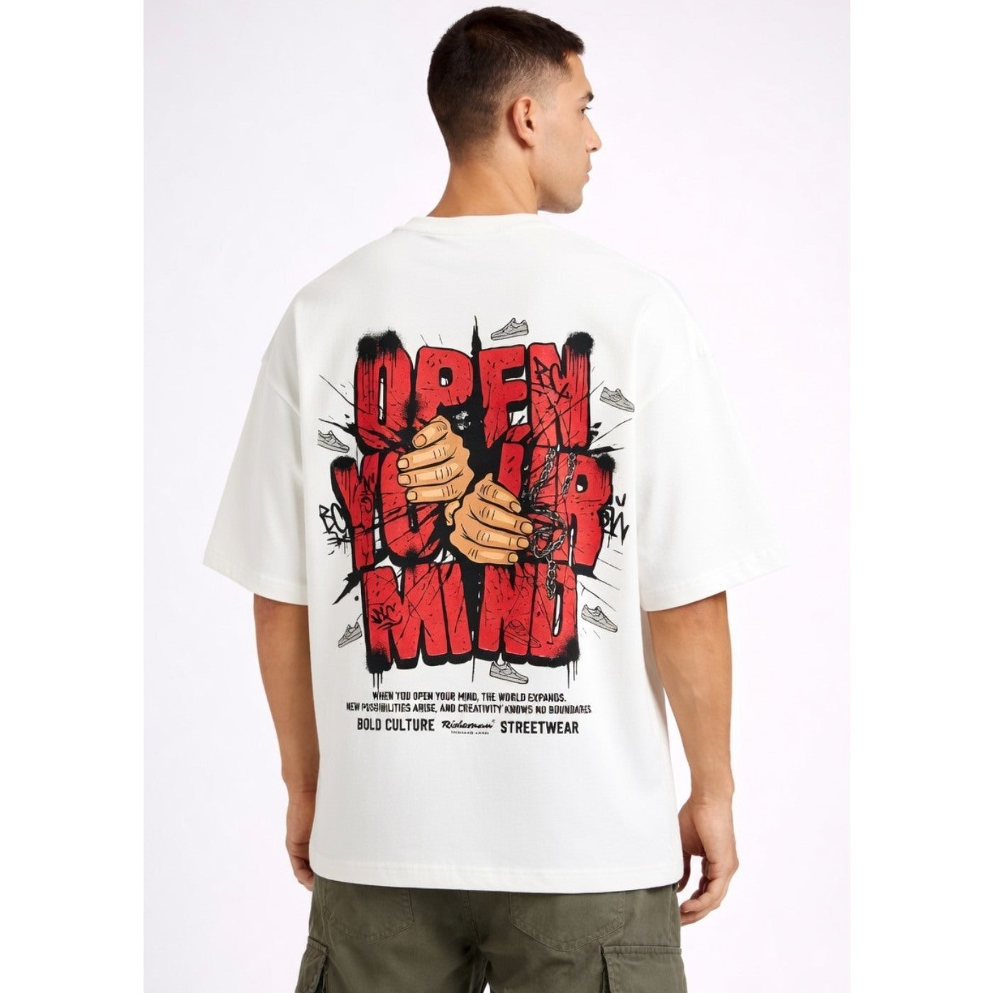 Man wearing a white t-shirt with graphic design and text on the back