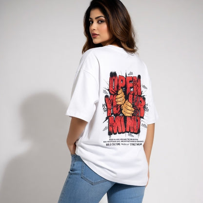 Person wearing a white t-shirt with a graphic design on the back, standing against a plain background