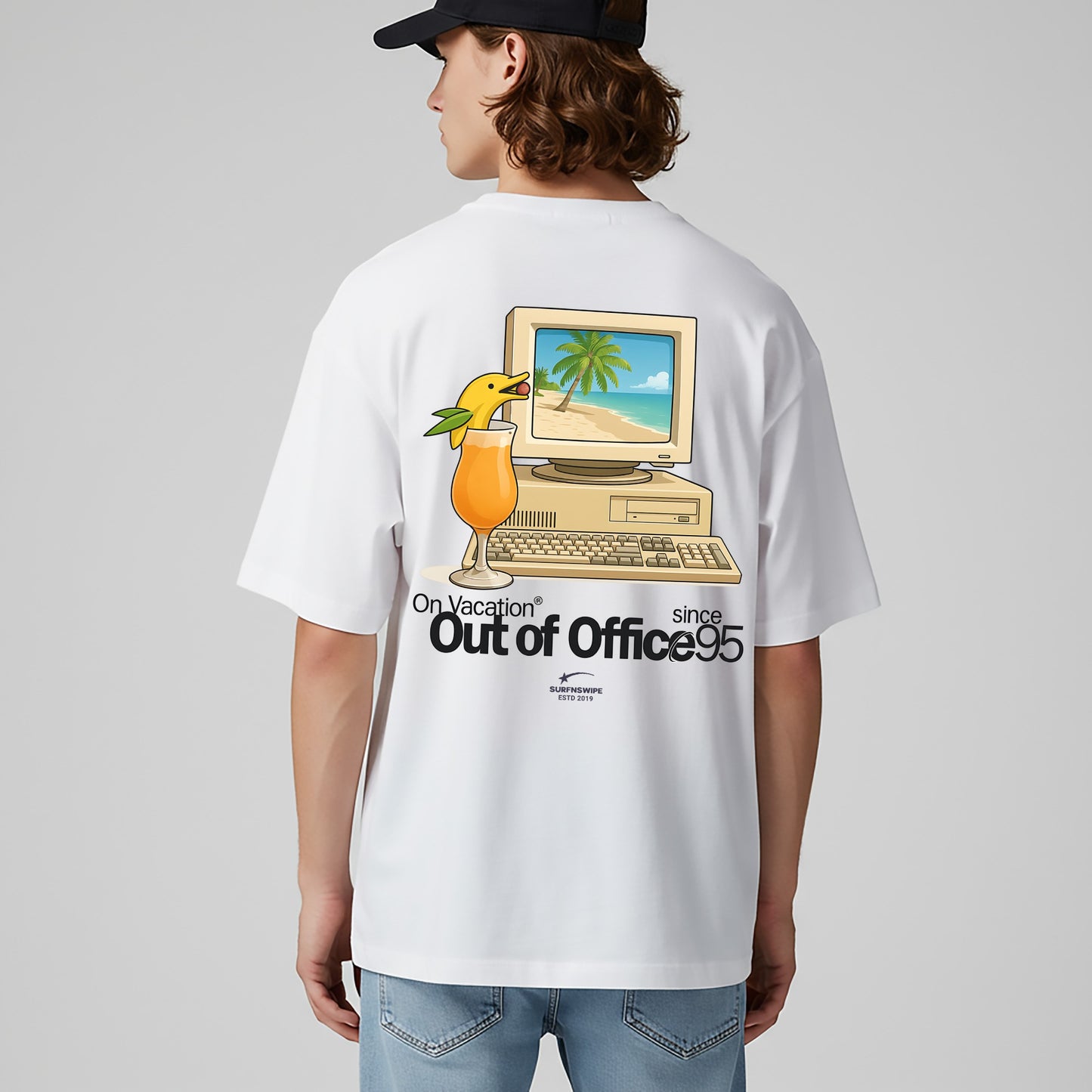 Person wearing a white t-shirt with a graphic design on the back, featuring a computer and palm tree, on a plain background.