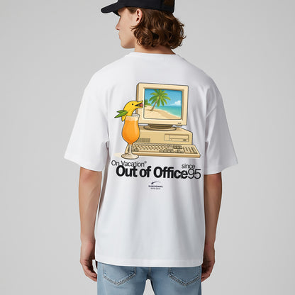 Person wearing a white t-shirt with a graphic design on the back, featuring a computer and palm tree, on a plain background.