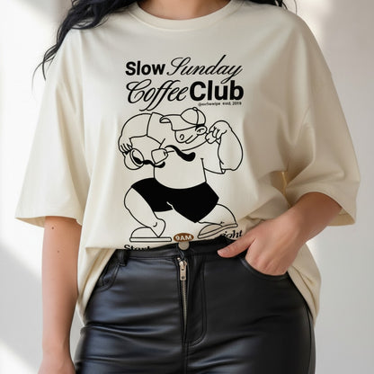 Person wearing a white t-shirt with a graphic design and text on a plain background