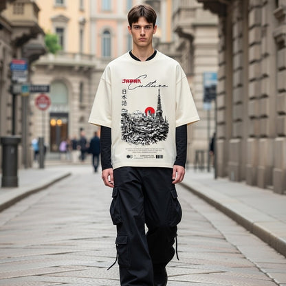 Person wearing a white t-shirt with a graphic design on a city street