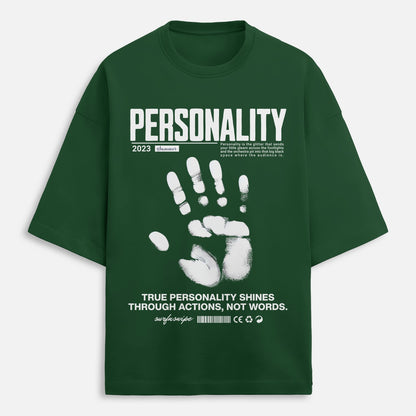 Person wearing a green t-shirt with text and graphics, standing against a brown background