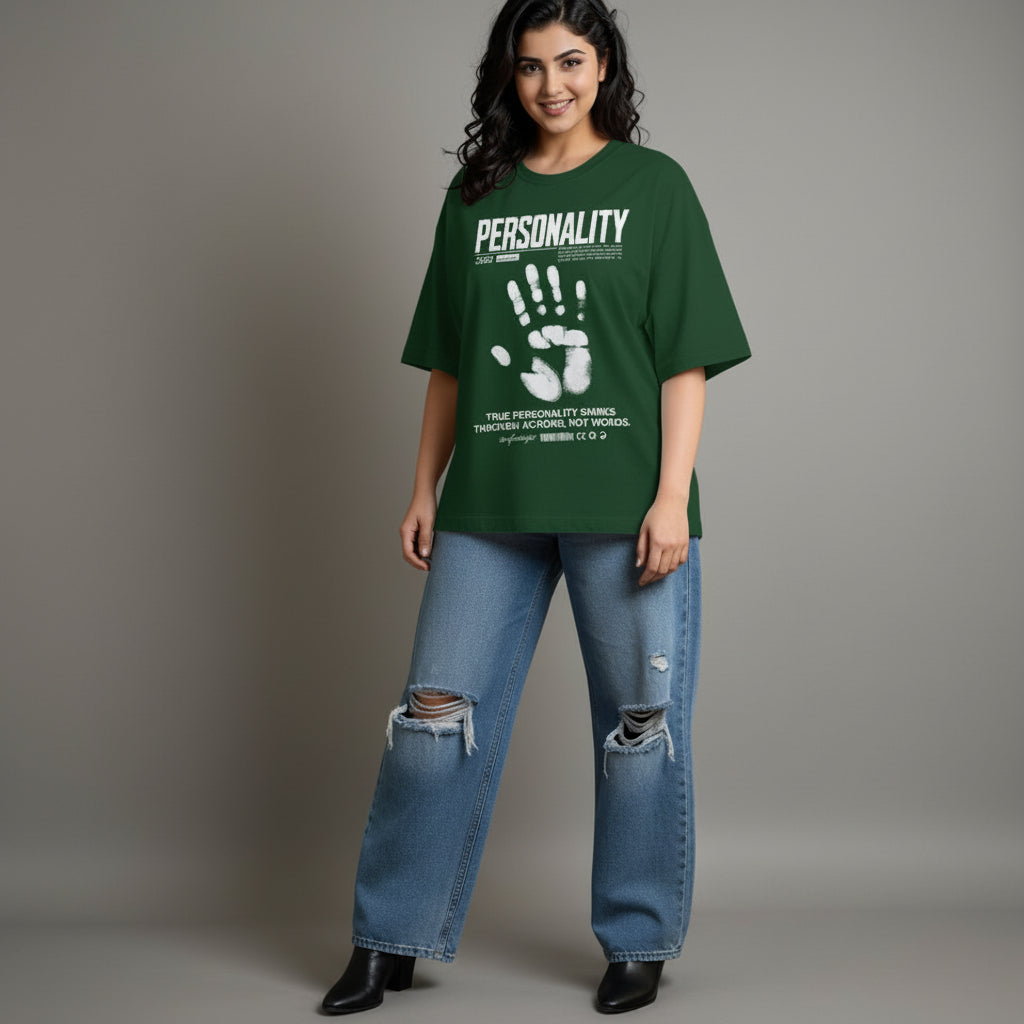 Person wearing a green t-shirt with text and graphics, standing against a plain background
