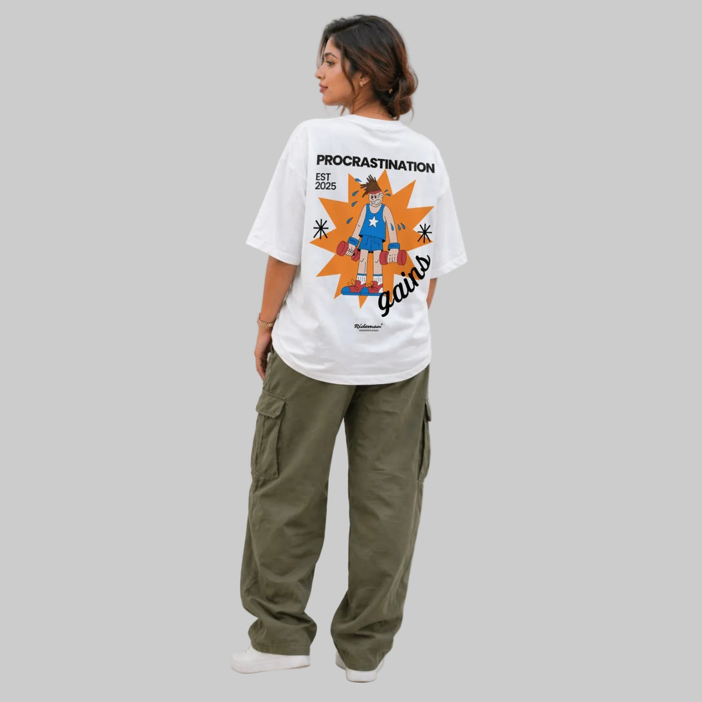 Person wearing a white t-shirt with a graphic design and text, standing against a plain background