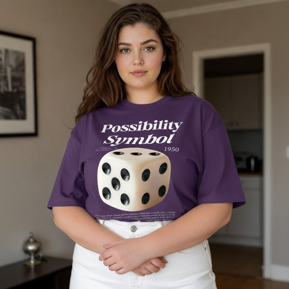 Person wearing a purple t-shirt with a dice graphic and text in a room.