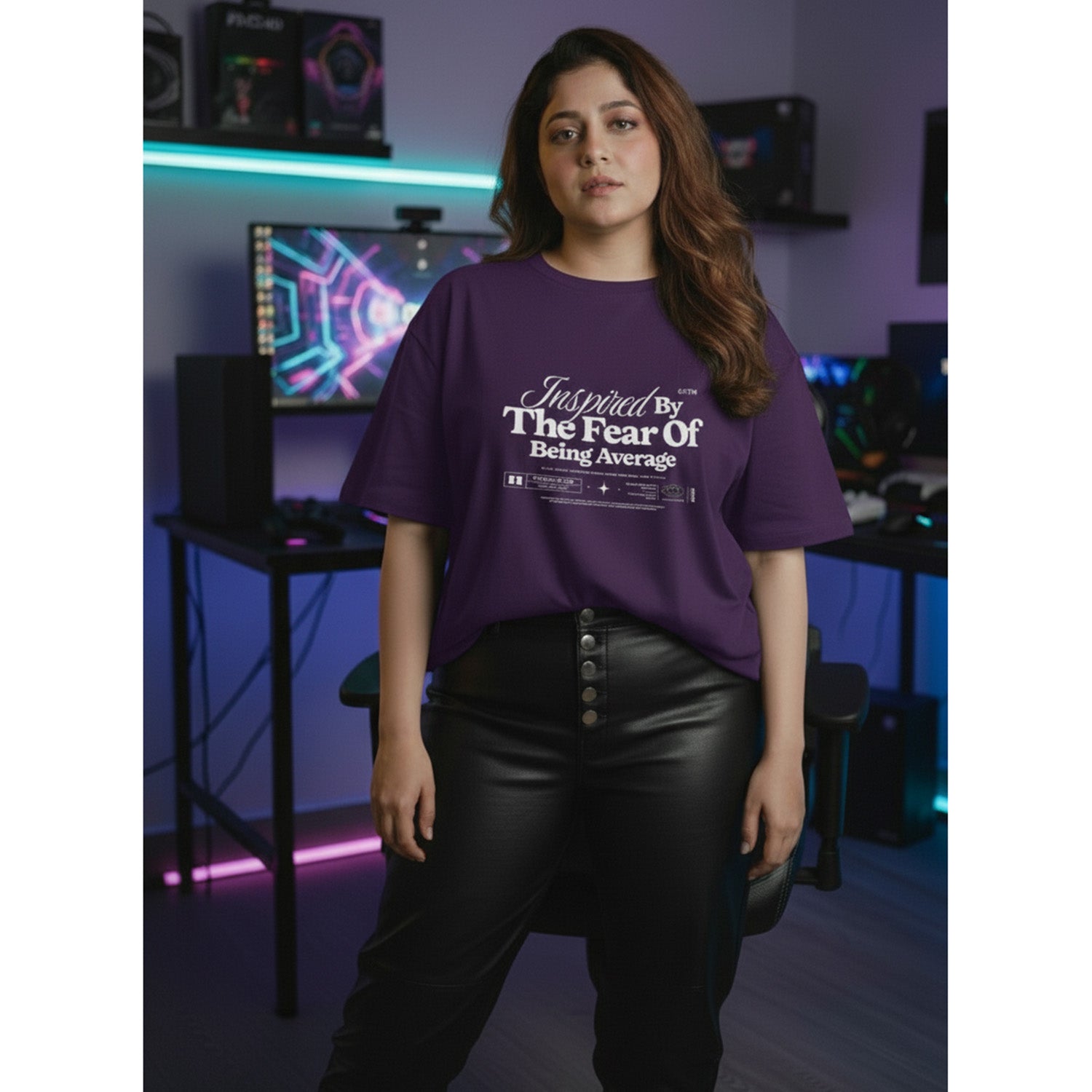 Person wearing a purple t-shirt with text in a room with gaming equipment.