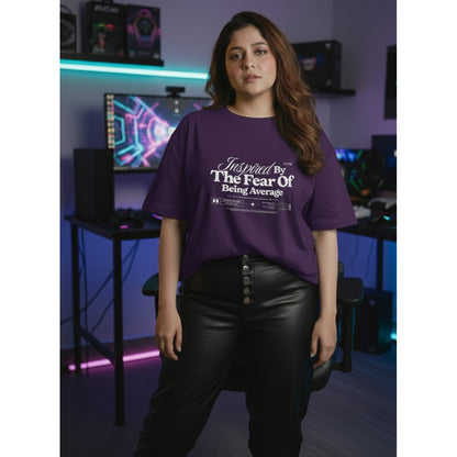 Person wearing a purple t-shirt with text in a room with gaming equipment.
