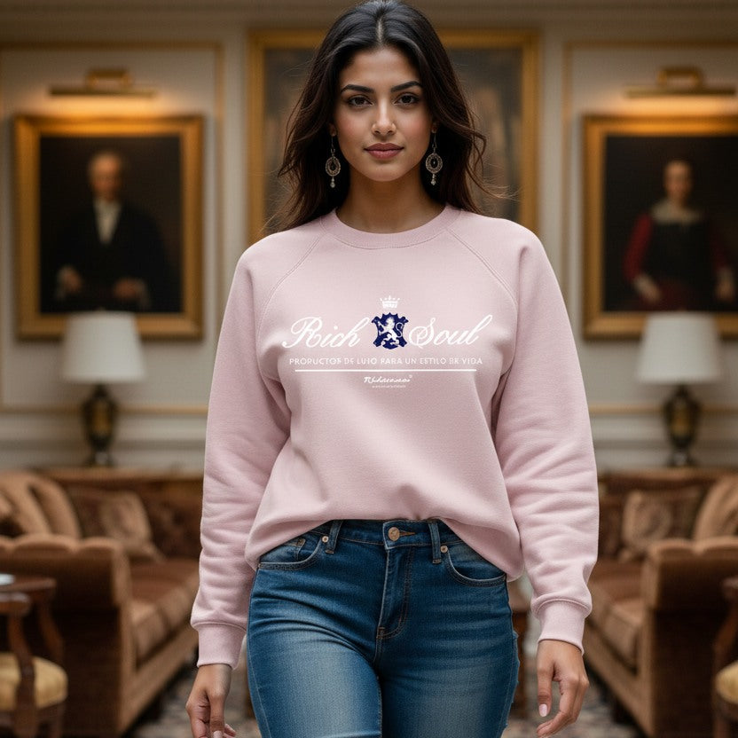 Woman wearing a pink sweatshirt with 'Rich Soul' design in an elegant room.