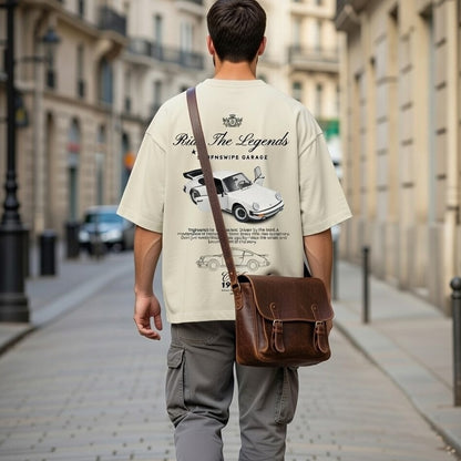Person wearing a t-shirt with a graphic design walking down a city street.