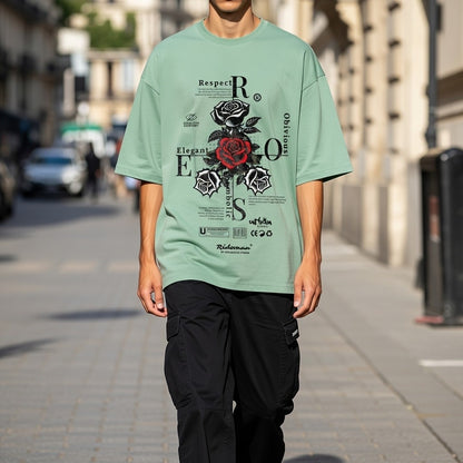 Person wearing a green t-shirt with a graphic design on a city street.