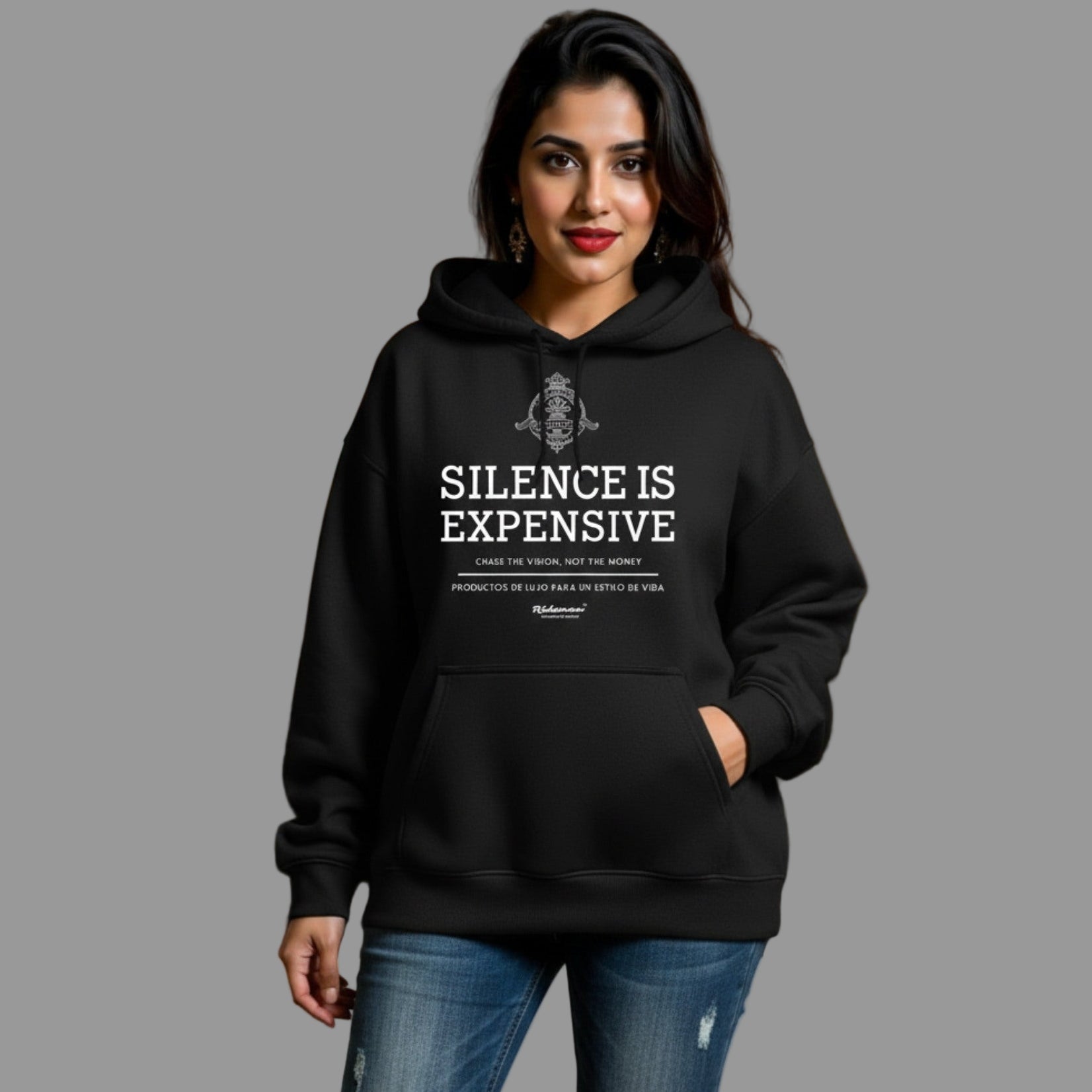 Person wearing a black hoodie with 'Silence is Expensive' text, standing indoors.
