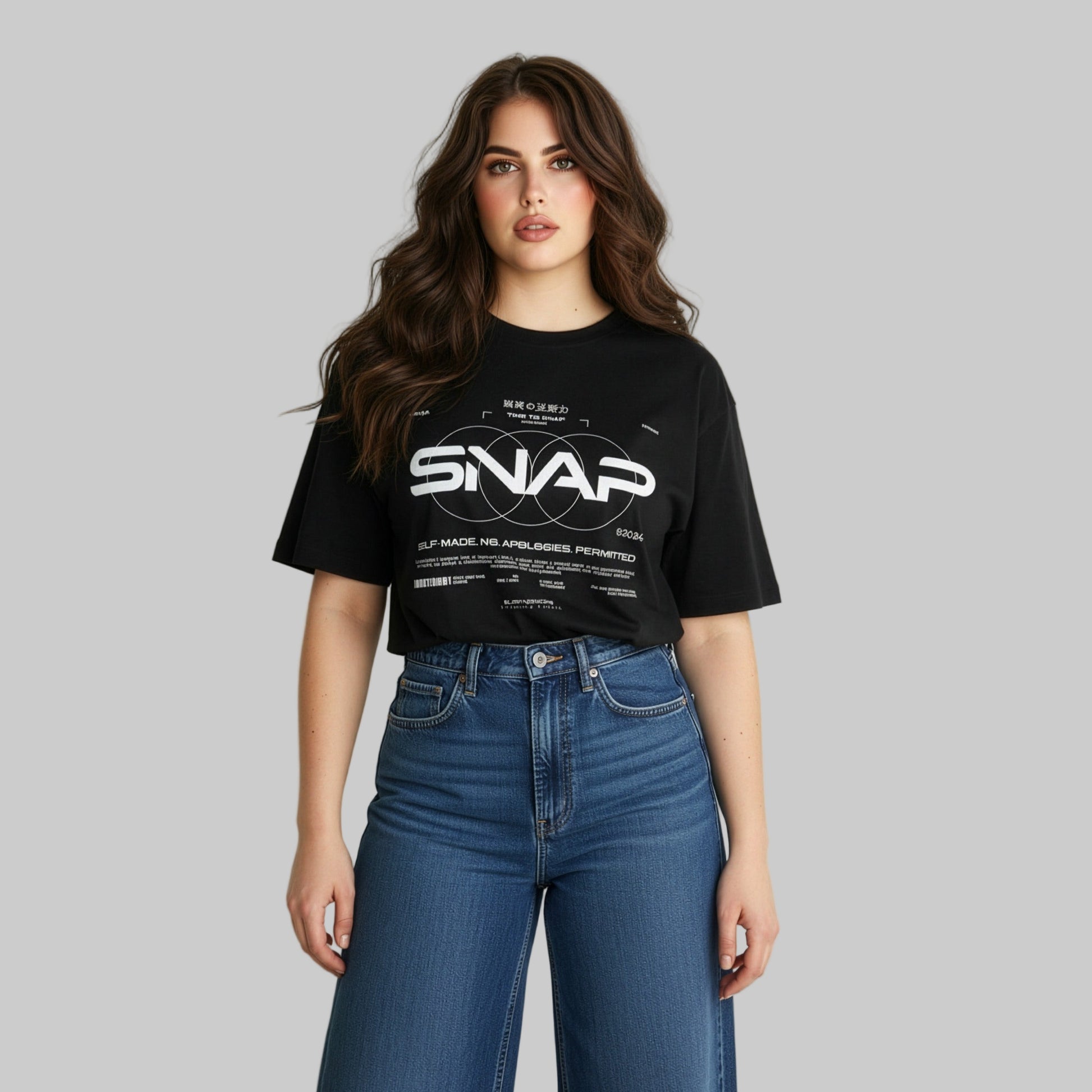 Woman wearing a black t-shirt with 'SNAP' logo and text, standing against a plain background