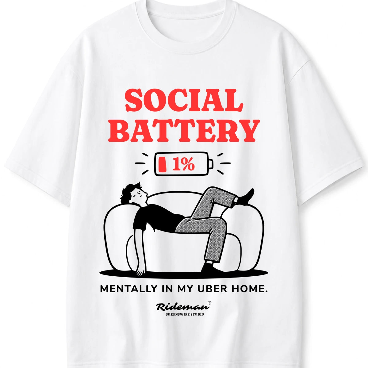 A white short-sleeve crewneck t-shirt featuring a graphic print. The design shows a cartoon man lounging on a couch with a 1% battery icon above him and the text 'SOCIAL BATTERY' in red, followed by 'MENTALLY IN MY UBER HOME.