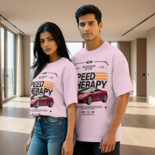 Two people wearing matching pink t-shirts with a car graphic and text.